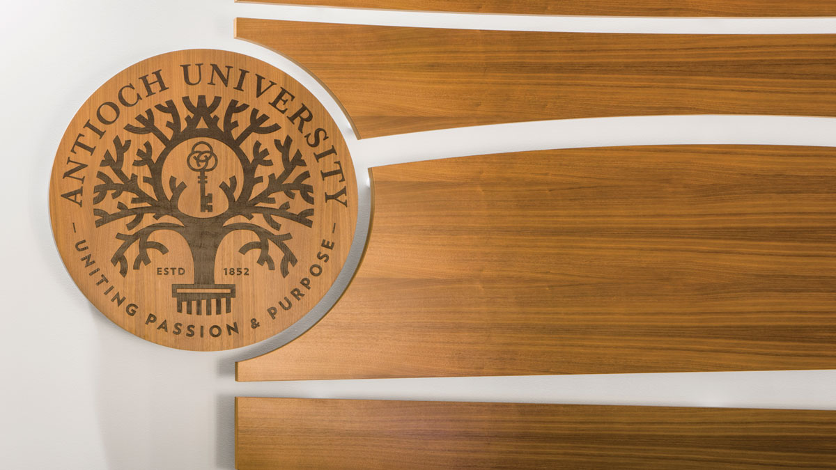 Antioch seal in wood with the words, uniting passion with purpose.
