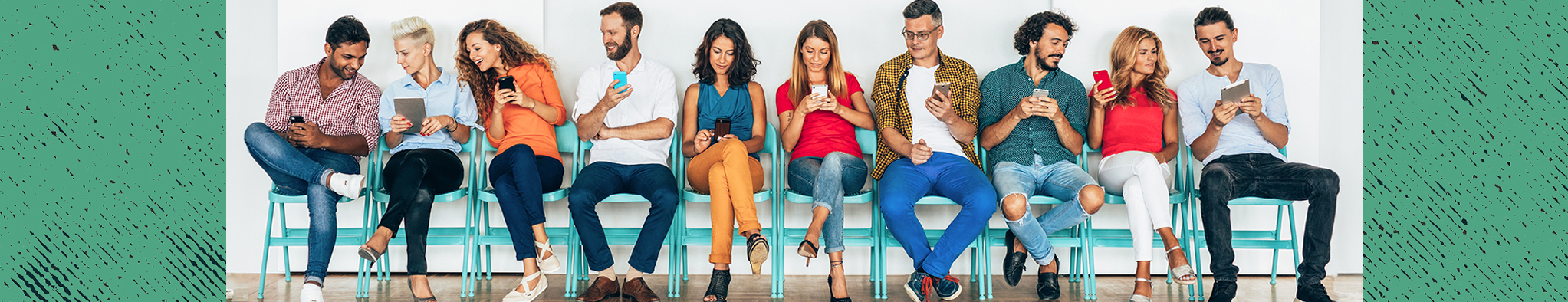 ten men and women sitting in blue chairs against a wall looking at their cell phones and tablets